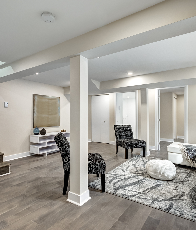 Basement with beam and vinyl floor.