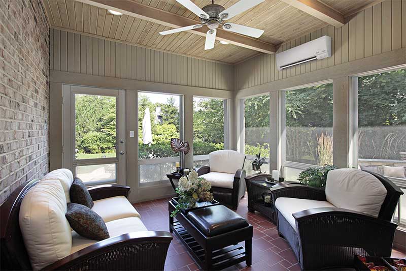 Heat pump in living room with big bay windows.