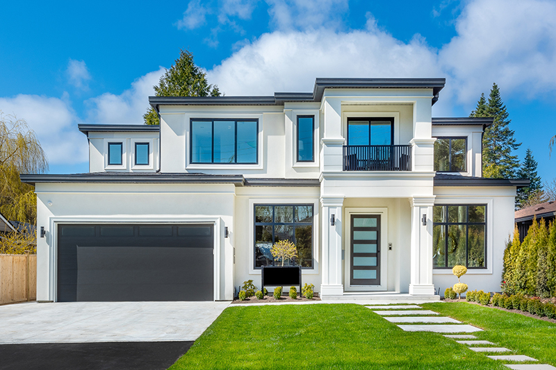 Front of house with big bay windows.