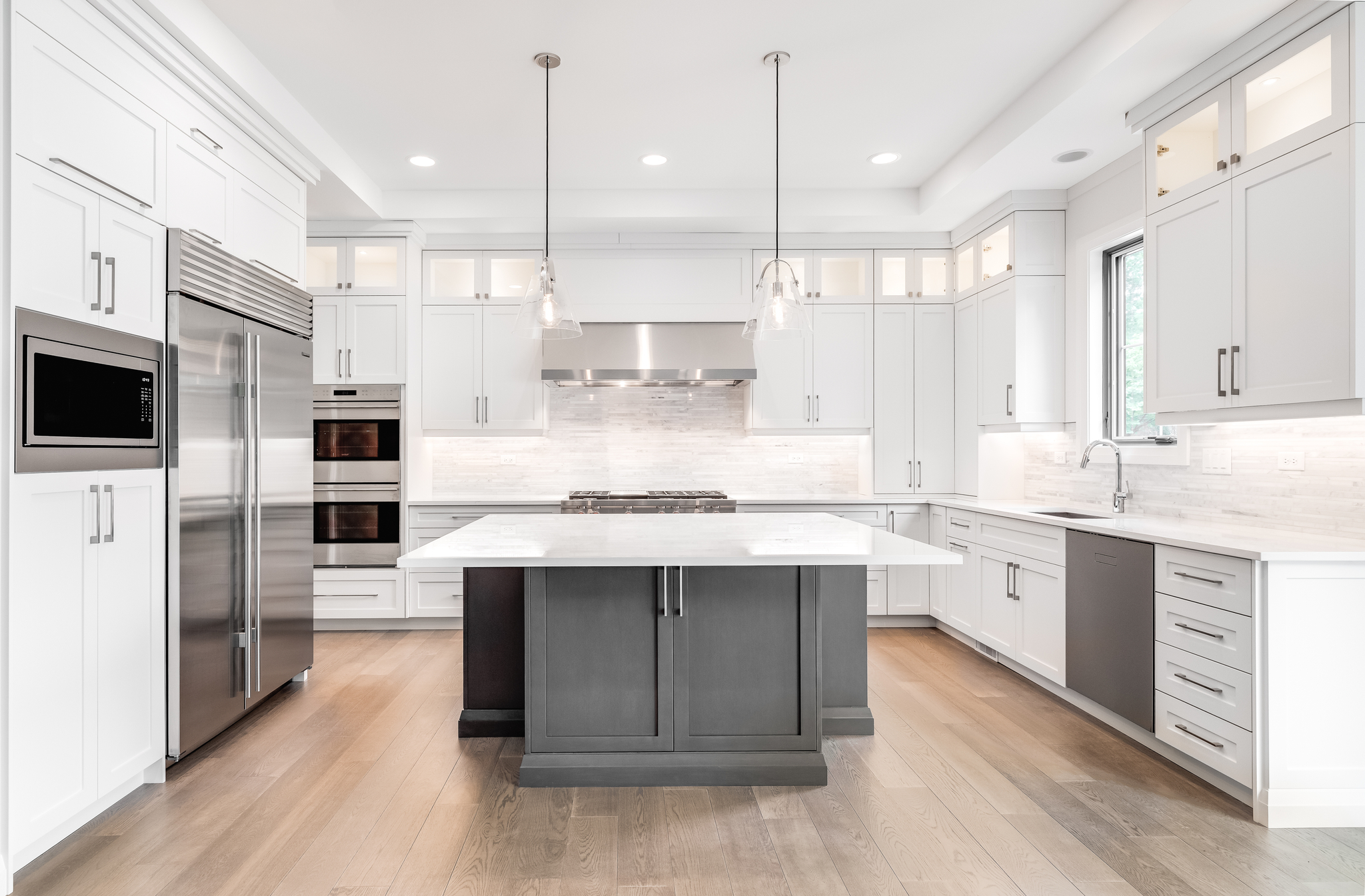 Modern kitchen with island and under-cabinet lightning.