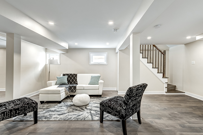 Basement with wood floors and windows.