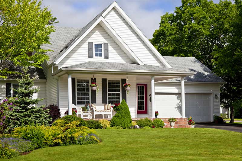 Front of house with porch and driveway.