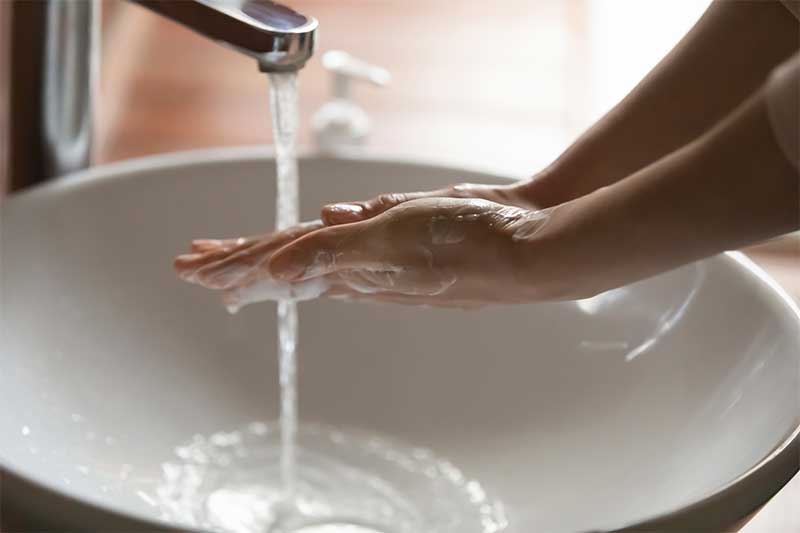 Women washing her hands.