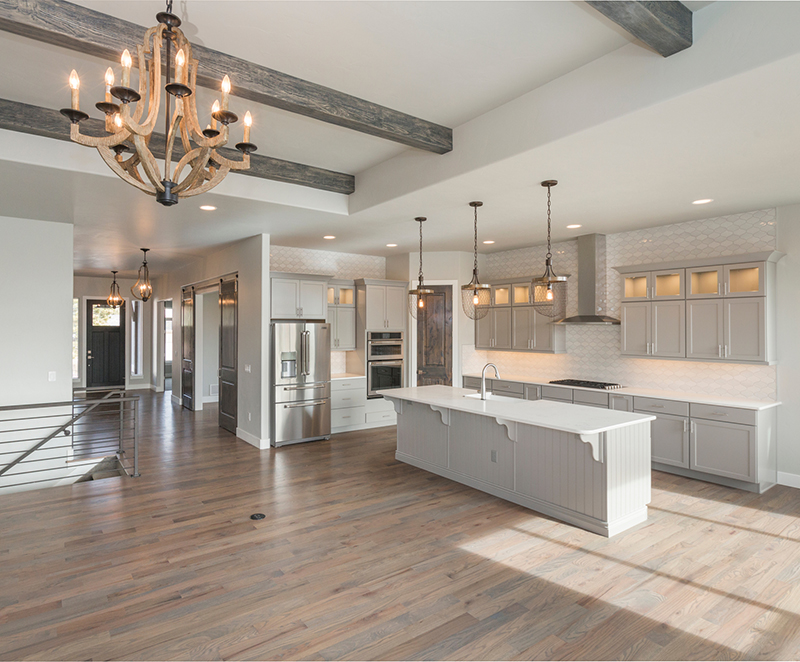 Open concept kitchen with living room with wood flooring.