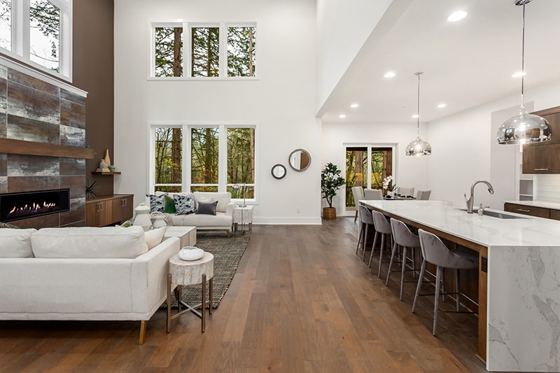 Open concept kitchen with living room and dining room with wood flooring.