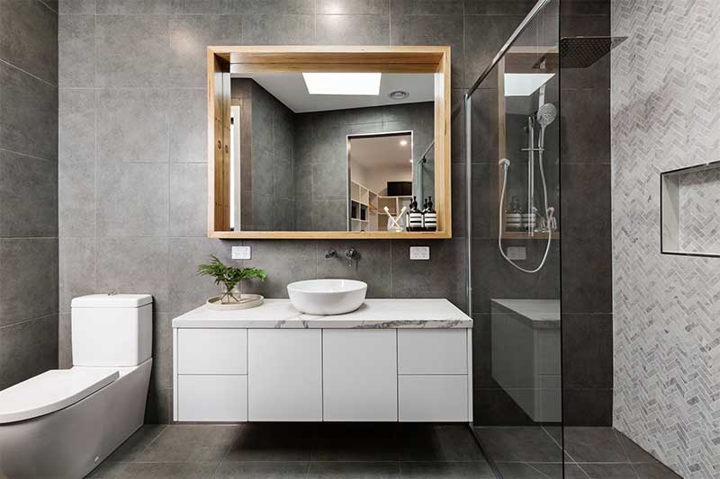 Modern bathroom with floating vanity and vessel sink.
